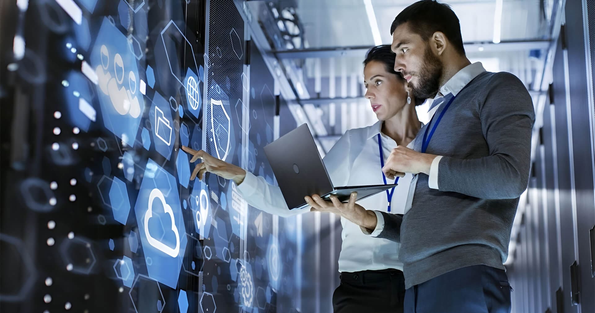 Two people are looking at a computer screen.